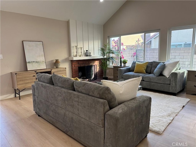 135 Ricci Ave, Walnut, CA 91789 - living area with high vaulted ceiling, healthy amount of natural light, light wood-style floors, and a brick fireplace