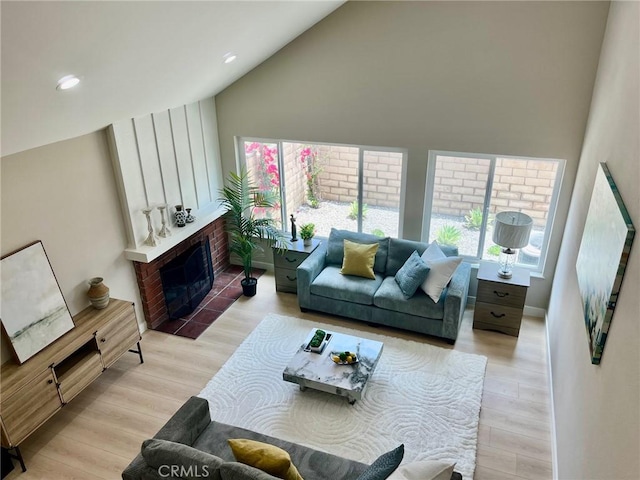135 Ricci Ave, Walnut, CA 91789 - living area featuring high vaulted ceiling, wood finished floors, a brick fireplace, and recessed lighting