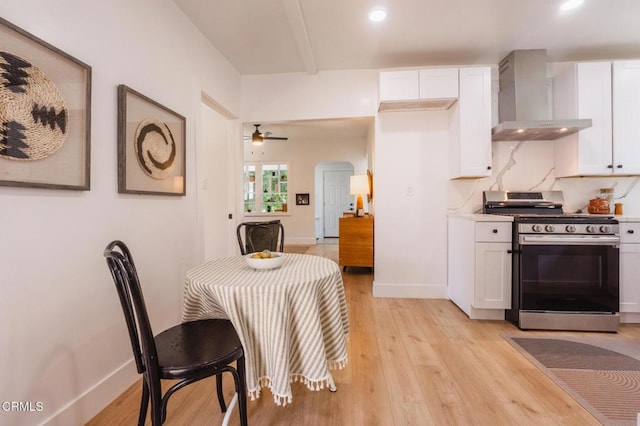 3538 Sierra St, Los Angeles, CA 90031 - kitchen featuring gas range, wall chimney exhaust hood, light wood-type flooring, white cabinetry, and recessed lighting