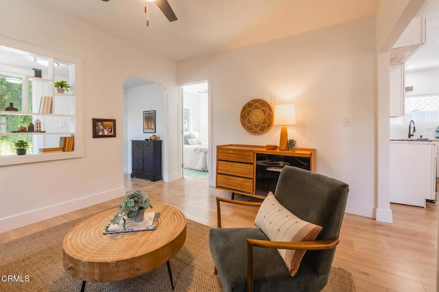 3538 Sierra St, Los Angeles, CA 90031 - sitting room featuring ceiling fan, arched walkways, light wood-type flooring, and baseboards