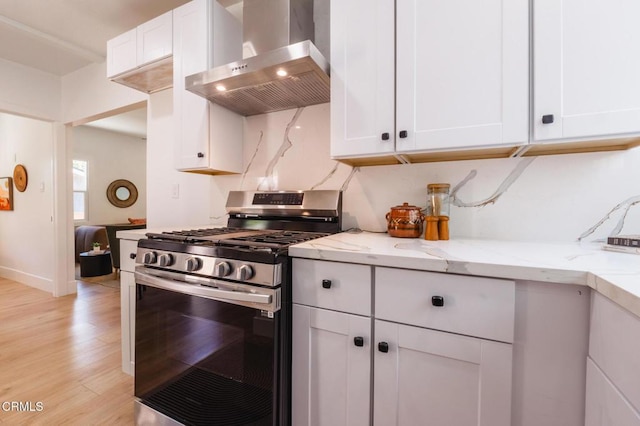 3538 Sierra St, Los Angeles, CA 90031 - kitchen featuring stainless steel gas range oven, wall chimney exhaust hood, and white cabinetry