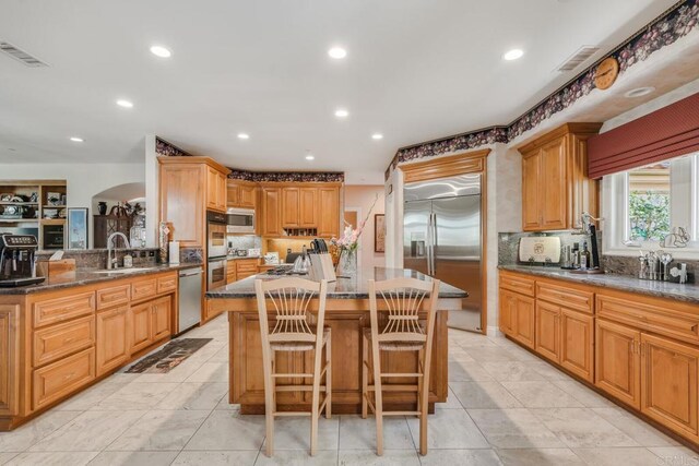 4014 Millagra Dr, Fallbrook, CA 92028 - kitchen with built in appliances, a sink, a center island, recessed lighting, and dark stone counters
