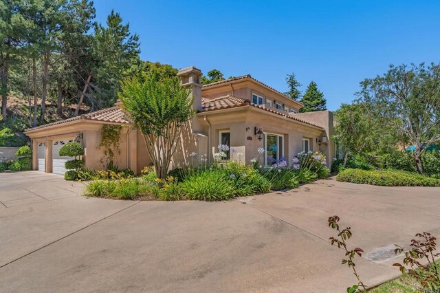 4014 Millagra Dr, Fallbrook, CA 92028 - mediterranean / spanish-style home with driveway, a tile roof, a garage, and stucco siding