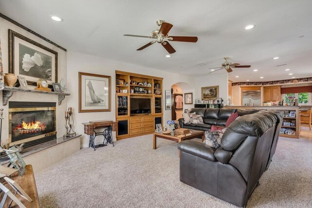 4014 Millagra Dr, Fallbrook, CA 92028 - carpeted living area featuring arched walkways, a ceiling fan, recessed lighting, and a fireplace
