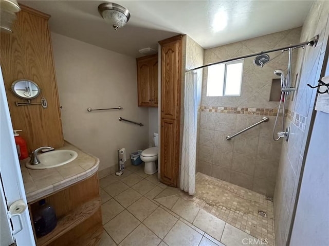 60645 Lupin Ln, Anza, CA 92539 - bathroom featuring vanity, tiled shower, tile patterned floors, and toilet