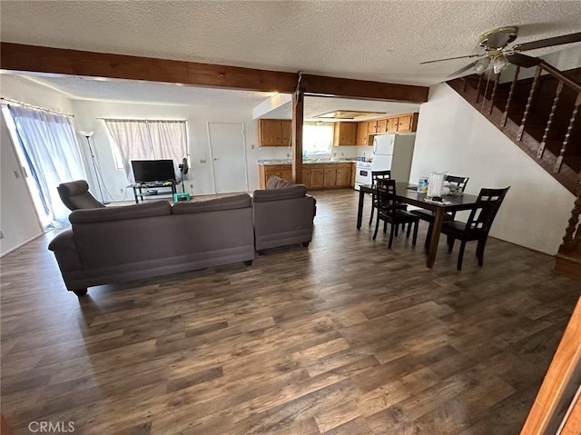 60645 Lupin Ln, Anza, CA 92539 - living area with dark wood-style floors, a textured ceiling, a ceiling fan, beam ceiling, and stairs