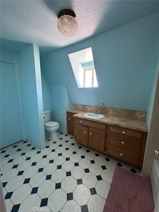 60645 Lupin Ln, Anza, CA 92539 - bathroom with toilet, vanity, a textured ceiling, and tile patterned floors