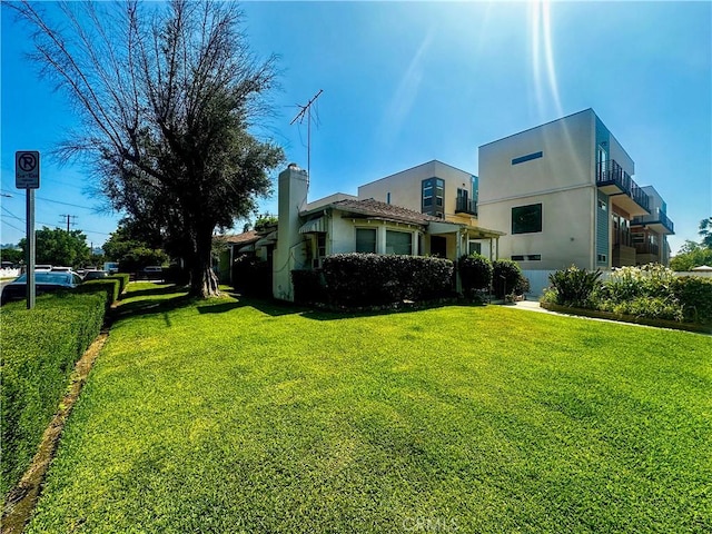 10802 Morrison St, North Hollywood, CA 91601 - rear view of property featuring a lawn and stucco siding