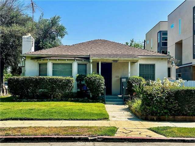 10802 Morrison St, North Hollywood, CA 91601 - bungalow-style house with stucco siding, a chimney, a front lawn, and a shingled roof