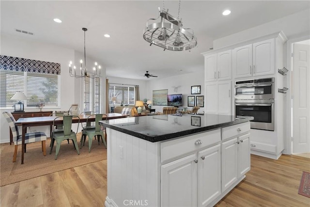19344 Macklin St, Apple Valley, CA 92308 - kitchen with stainless steel double oven, a chandelier, recessed lighting, light wood-type flooring, and dark countertops