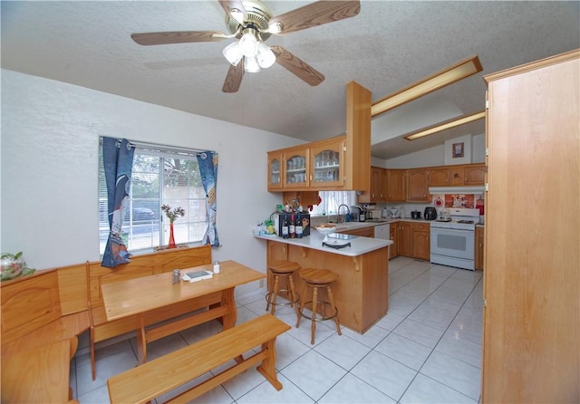 13182 Third St, Clearlake Oaks, CA 95423 - kitchen with white range oven, a peninsula, a textured ceiling, lofted ceiling, and glass insert cabinets