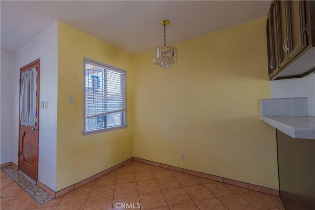 7227 Farmland Ave, Pico Rivera, CA 90660 - unfurnished dining area with light tile patterned floors and baseboards