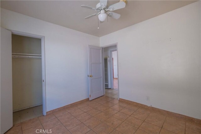 7227 Farmland Ave, Pico Rivera, CA 90660 - unfurnished bedroom with a closet, ceiling fan, baseboards, and light tile patterned floors