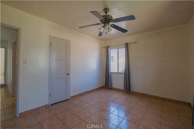 7227 Farmland Ave, Pico Rivera, CA 90660 - spare room with a ceiling fan, light tile patterned flooring, and baseboards