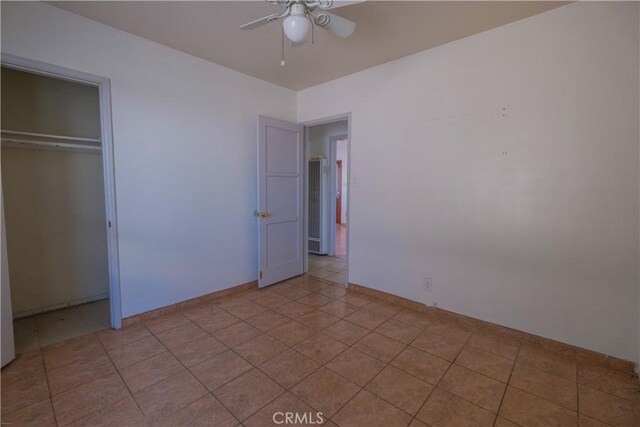 7227 Farmland Ave, Pico Rivera, CA 90660 - unfurnished bedroom featuring a closet, baseboards, light tile patterned floors, and ceiling fan