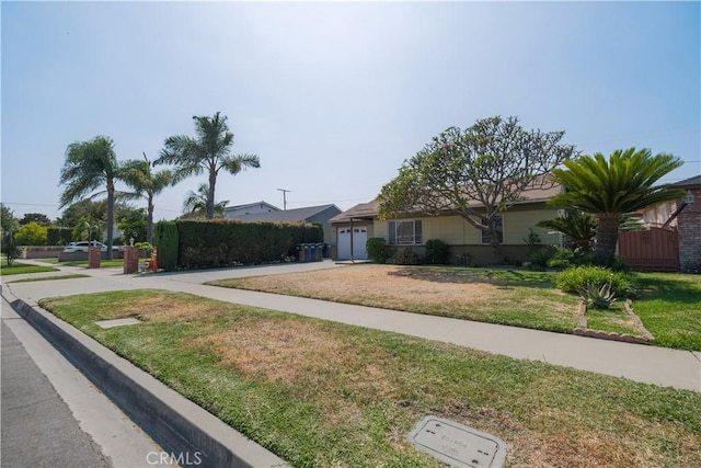 7227 Farmland Ave, Pico Rivera, CA 90660 - ranch-style house featuring concrete driveway, a garage, and a front lawn