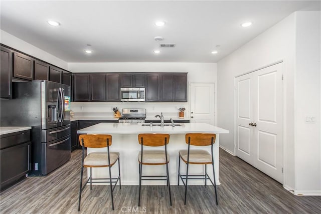 1737 Arcus Ct, Beaumont, CA 92223 - kitchen featuring appliances with stainless steel finishes, a sink, a breakfast bar area, light countertops, and recessed lighting