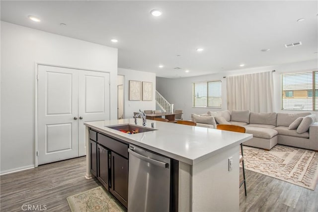 1737 Arcus Ct, Beaumont, CA 92223 - kitchen with dishwasher, a sink, wood finished floors, an island with sink, and light countertops