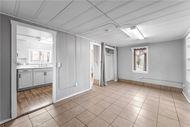 59485 State Highway 74, Mountain Center, CA 92561 - unfurnished bedroom with multiple windows, light tile patterned floors, a sink, and baseboards