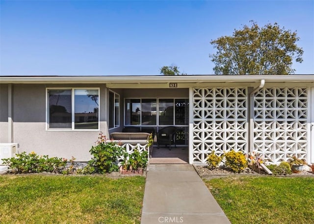 13881 Thunderbird Dr Unit M1-63E, Seal Beach, CA 90740 - doorway to property featuring a lawn and a porch