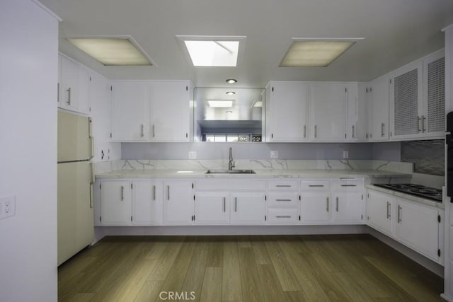 13881 Thunderbird Dr Unit M1-63E, Seal Beach, CA 90740 - kitchen with freestanding refrigerator, a sink, white cabinetry, open shelves, and black electric stovetop