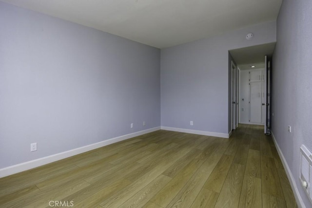13881 Thunderbird Dr Unit M1-63E, Seal Beach, CA 90740 - spare room with light wood finished floors, baseboards, and a smoke detector
