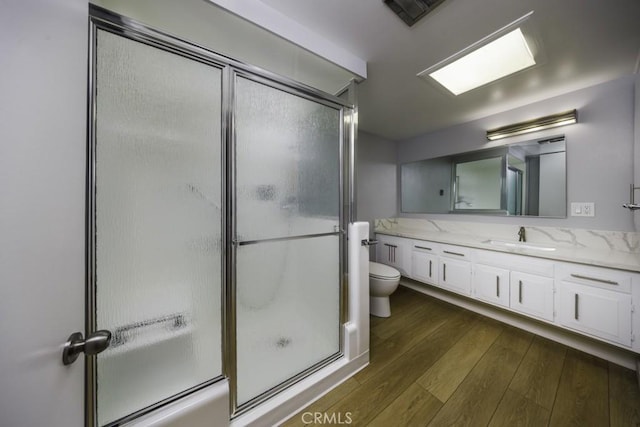 13881 Thunderbird Dr Unit M1-63E, Seal Beach, CA 90740 - full bathroom featuring toilet, vanity, a shower stall, and wood finished floors