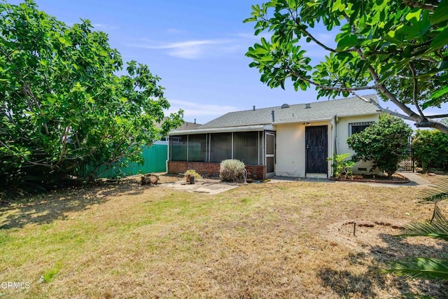 8730 Marshall St, Rosemead, CA 91770 - rear view of property with a sunroom, a yard, and stucco siding