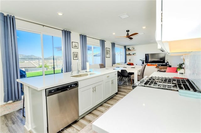 28252 Farm Creek Way, Valley Center, CA 92082 - kitchen with stainless steel appliances, light wood-style flooring, a kitchen island with sink, light countertops, and white cabinetry