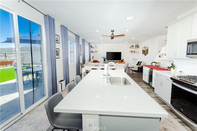 28252 Farm Creek Way, Valley Center, CA 92082 - kitchen with stainless steel appliances, white cabinets, light countertops, a kitchen breakfast bar, and recessed lighting
