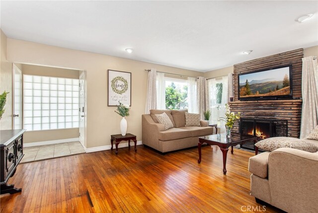 5342 Kingsley St, Montclair, CA 91763 - living area featuring a large fireplace and light wood finished floors