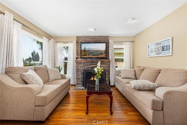 5342 Kingsley St, Montclair, CA 91763 - living area with wood finished floors, plenty of natural light, and a fireplace