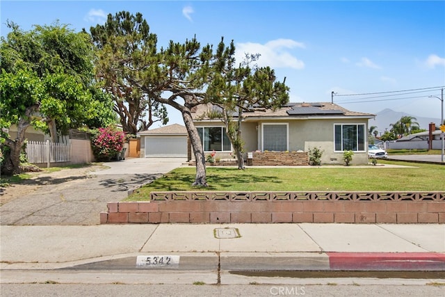 5342 Kingsley St, Montclair, CA 91763 - view of front of home featuring stucco siding, solar panels, and a detached garage