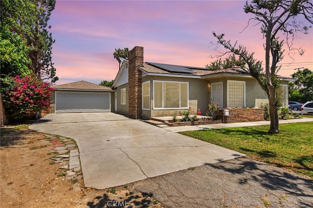 5342 Kingsley St, Montclair, CA 91763 - ranch-style home featuring a chimney, solar panels, stucco siding, a front lawn, and a garage