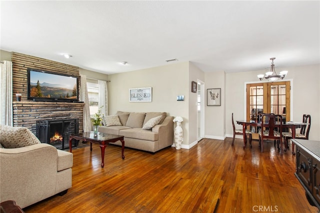 5342 Kingsley St, Montclair, CA 91763 - living room featuring a chandelier, dark wood-type flooring, and a large fireplace