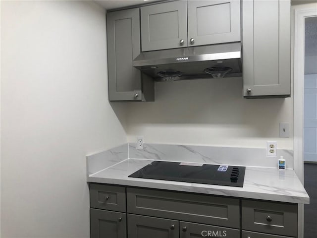 218 N Nicholson Ave, Monterey Park, CA 91755 - kitchen featuring under cabinet range hood, gray cabinets, black electric cooktop, and light stone counters