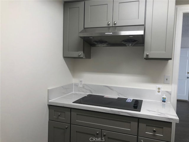 218 N Nicholson Ave, Monterey Park, CA 91755 - kitchen featuring under cabinet range hood, gray cabinetry, black electric stovetop, and light stone countertops
