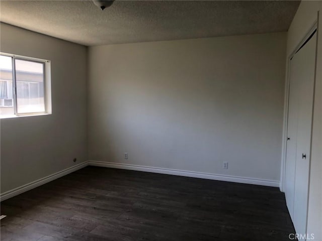 218 N Nicholson Ave, Monterey Park, CA 91755 - spare room featuring a textured ceiling, dark wood-type flooring, and baseboards