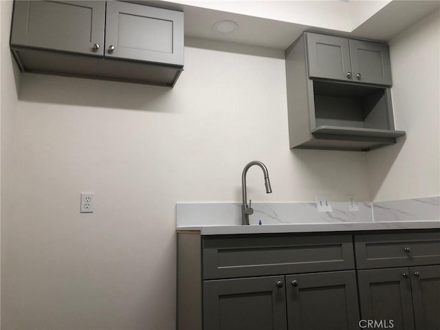 218 N Nicholson Ave, Monterey Park, CA 91755 - kitchen with gray cabinets, light stone counters, and a sink