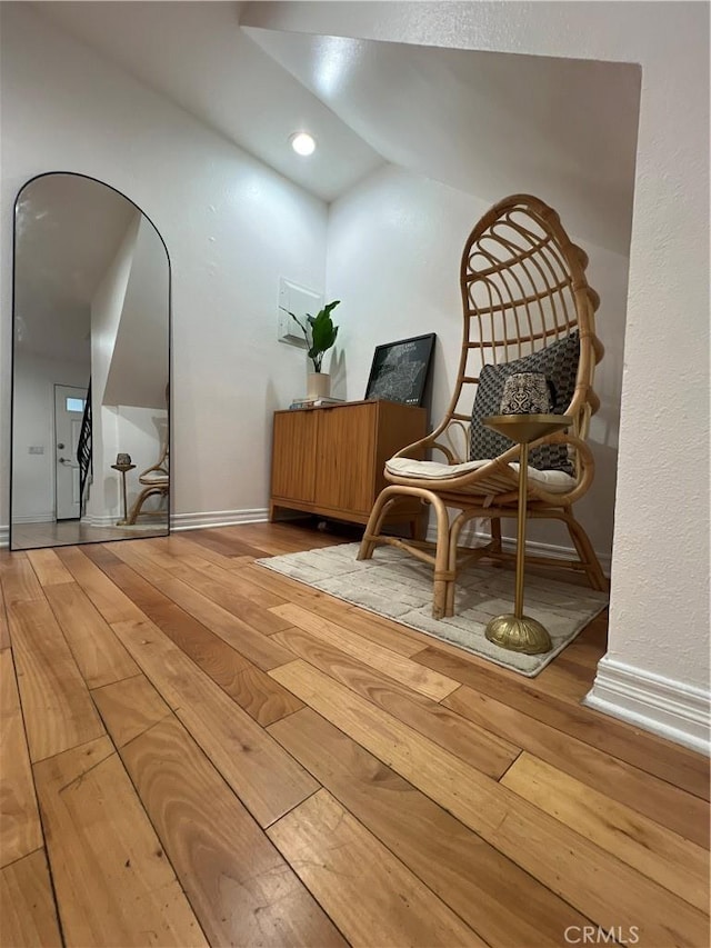 4113 E 10th St Unit 2, Long Beach, CA 90804 - sitting room featuring hardwood / wood-style flooring, lofted ceiling, baseboards, and arched walkways