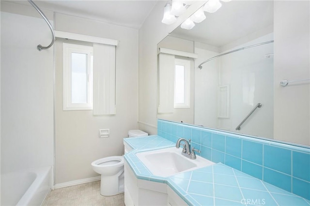 1401 N Linwood Ave, Santa Ana, CA 92701 - bathroom with toilet, vanity, baseboards, shower / bathtub combination, and backsplash