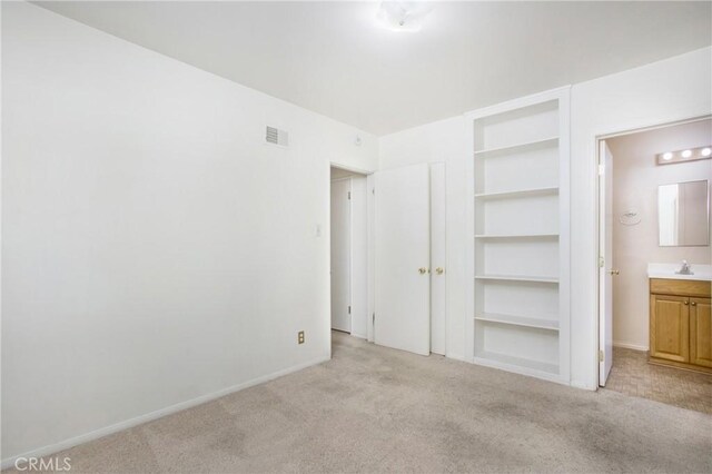 1401 N Linwood Ave, Santa Ana, CA 92701 - unfurnished bedroom featuring light colored carpet, a sink, and baseboards