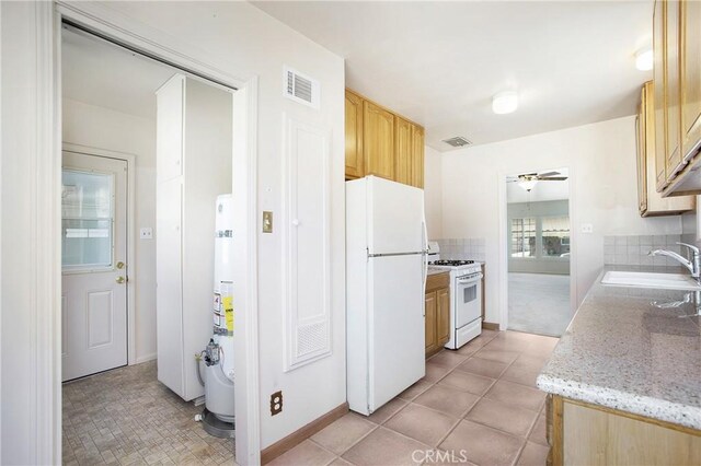 1401 N Linwood Ave, Santa Ana, CA 92701 - kitchen with white appliances, a sink, light brown cabinetry, a ceiling fan, and baseboards