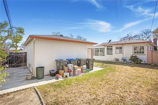 1401 N Linwood Ave, Santa Ana, CA 92701 - rear view of house featuring stucco siding and a sunroom