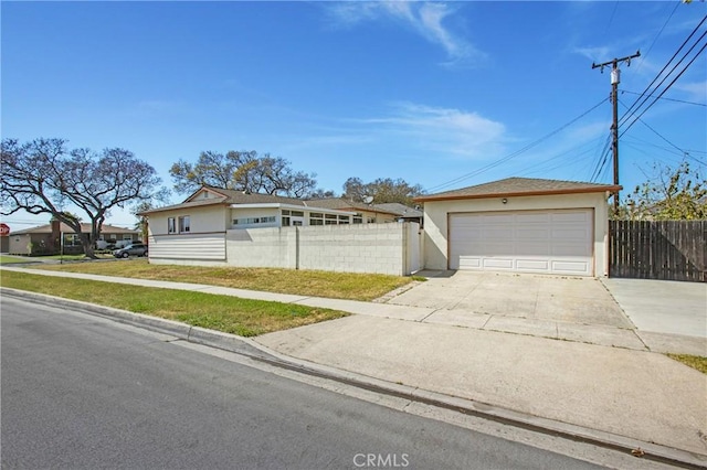 1401 N Linwood Ave, Santa Ana, CA 92701 - view of front of property with stucco siding, concrete driveway, and a garage