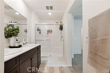 7155 Citrus Ave Unit 320, Fontana, CA 92336 - bathroom featuring a shower stall and double vanity