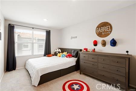7155 Citrus Ave Unit 320, Fontana, CA 92336 - bedroom with light carpet and baseboards