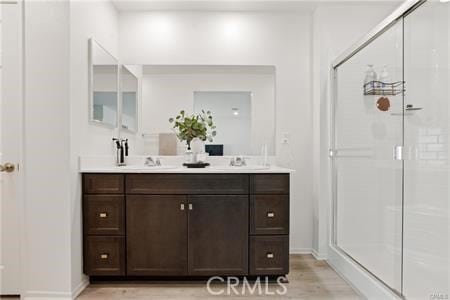 7155 Citrus Ave Unit 320, Fontana, CA 92336 - bathroom with double vanity, wood finished floors, and a shower stall