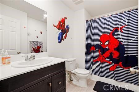 7155 Citrus Ave Unit 320, Fontana, CA 92336 - bathroom with vanity, curtained shower, and tile patterned floors