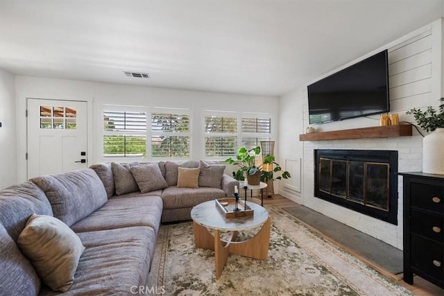 7560 Castano Ave, Atascadero, CA 93422 - living area featuring healthy amount of natural light and a brick fireplace